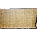 A large wool embroidered throw, the cream ground applied with a golden coloured wool,