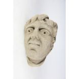 Two Medieval style carved stone heads of men / saints, each of weathered appearance,