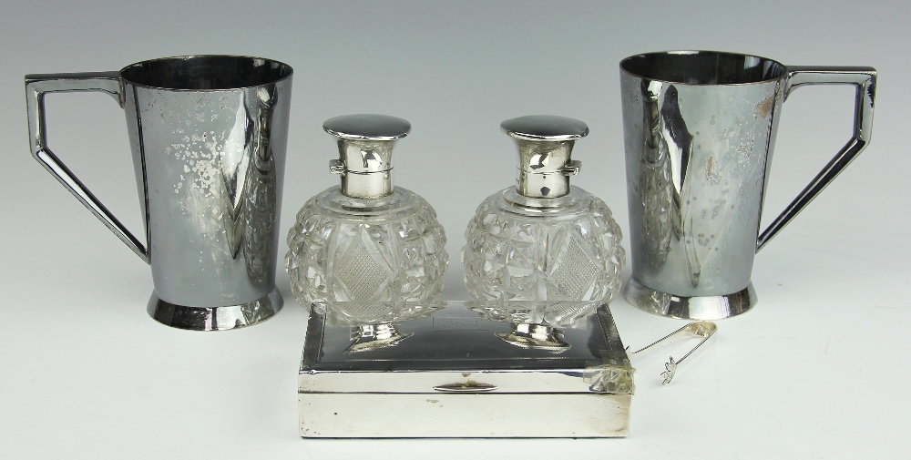 A pair of silver topped cut glass scent bottles and stoppers, Walker and Hall, Sheffield, 1922,