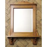 An Edwardian walnut wall mirror, with shelf,