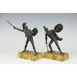 A pair of bronze figures after the antique, each standing warrior raised on marbled plinth base, 17.