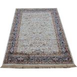 A Kashmir rug, worked with a foliate tree of life design against an ivory ground,