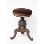 A Victorian carved oak music stool,