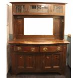 An Arts and Crafts inlaid oak dresser in the manner of Liberty and Co,