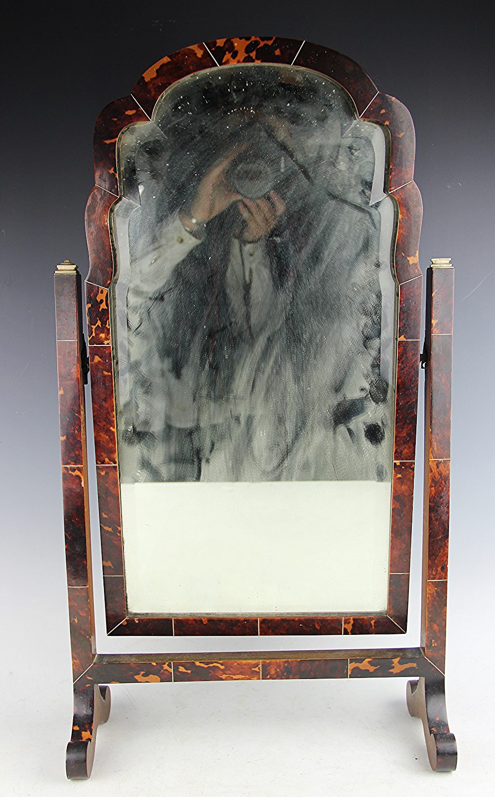 A 1920's Queen Anne style tortoiseshell toilet mirror, with bevelled plate,