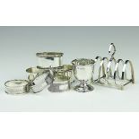 Six silver napkin rings, along with a silver toast rack, Barker Bros Ltd, Birmngham 1939,