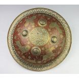 A Persian pierced brass shield, decorated with animals and warriors on horseback,