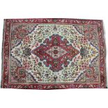 A small Persian wool rug, worked with a foliate design against an ivory ground,