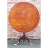 A George III mahogany tilt top occasional table, with turned column on tripod base,