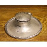 A silver capstan inkwell, A & J Zimmerman, Birmingham 1911, of typical concave form, loaded,