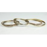 A 9ct tri-colour gold triple bangle, to include a white, rose and yellow gold bangle,