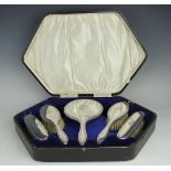 A cased silver backed dressing table brush set, three brushes, Henry Clifford Davis,