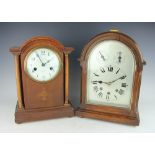 A Victorian oak cased mantle clock, the domed cased enclosing a silvered dial, 34cm high,