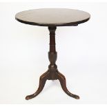 A George III mahogany tilt top tripod table, the solid top upon a vase turned column,