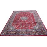 A Kashan red ground wool carpet,