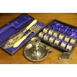 A cased set of twelve napkin rings, each with feather engraved detail, within fitted case,