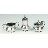 A three piece silver condiment set, with Celtic strapwork, Walker and Hall, Sheffield 1913,