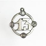 A diamond set '13' pendant, all set in white metal and set within a four diamond surround, unmarked,