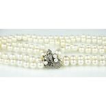 A graduated cultured pearl necklace with diamond set clasp,