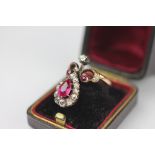 A SYNTHETIC ruby and diamond set dress ring,