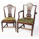 Seven George III style mahogany dining chairs, including one with arms,