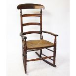 A 19th century beech rocking chair, with rush seat,