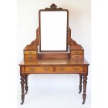 A Victorian mahogany dressing table in aesthetic style, the central mirror surmounted with shell,