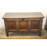 A late 17th century oak coffer, with three panel front and later carved detailing, on stile feet,