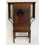 An Edwardian mahogany display cabinet, with three drawers and glazed door, with gallery sides,
