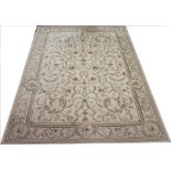 A machine woven carpet, worked with scrolling floral design against a cream ground,