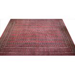 A Bokhara carpet, worked with rows of gulls against a red ground,