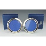 A pair of silver circular photograph frames, Broadway & Co, Birmingham 1986, with beaded detail,