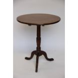 A George III mahogany circular occasional table, with turned column, on tripod base,