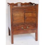 A George III mahogany tray top commode, with two drawers and two cupboard doors, on chamfered legs,