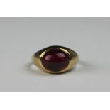 A garnet set 9ct yellow gold signet ring, set with an oval cabochon stone, weight 3.