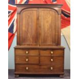 A William IV mahogany linen press, converted for hanging, with two arched panelled doors,