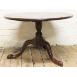 A George III mahogany circular tripod table, on carved legs, (reduced),