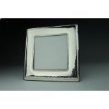 A silver photograph frame, contemporary, of plain planished square form, stamped '925',