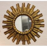 A George III style carved gilt wood and gesso wall mirror, 76cm H, with a sun burst mirror,