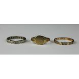 A 9ct yellow gold signet ring, and two stone set eternity rings, total weight 6.