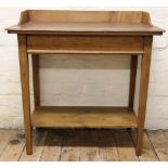 A late Victorian striped mahogany two tier wash stand, on tapered legs,