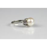 A pearl and diamond ring, the central untested pearl (measuring 8.