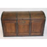 A stained pine dome top trunk, with carved and paper lined internal tray and twin brass handles,