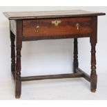 A late 17th century oak side table, with moulded three plank top above a drawer, on turned legs,