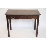 A George III mahogany side table, with three drawers, on chamfered and moulded legs,