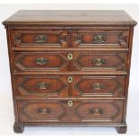 A 17th century Carolean oak chest, with four fielded long drawers, on later block feet (at fault),