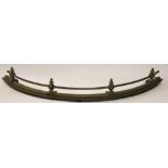 A 19th century steel and brass curved fender,