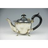A silver tea pot, Emile Viner Sheffield 1932, with ogee rim and raised on four out-swept legs,