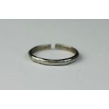 A white metal wedding band, stamped 'Platinum', total weight 2.