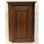 A George III oak and mahogany crossbanded hanging corner cabinet,